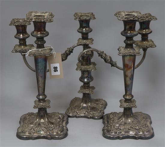 A pair of plated candlesticks and a plated candelabra